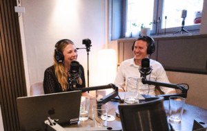Kvinna och man i poddstudio